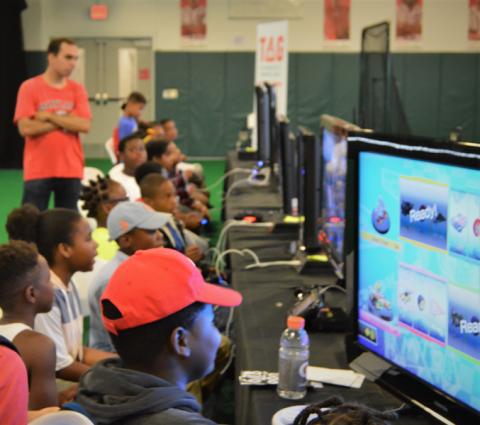 Kids competing in Mario Kart