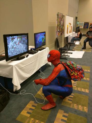Spiderman taking a break playing some games